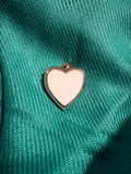Gold and white heart shaped locket